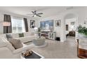 Bright living room features neutral walls, recessed lighting, tile floors and an electric fireplace at 149 Hickory Course Cir, Ocala, FL 34472