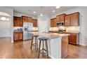 Spacious kitchen with granite countertops, stainless steel appliances, and a large center island with breakfast bar seating at 16137 Azure Key St, Winter Garden, FL 34787