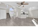 Open-concept living room featuring wood floors, a staircase, and an airy, open design at 1851 Wimbledon St, Kissimmee, FL 34743