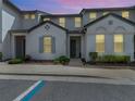 Inviting two-story townhome featuring neat landscaping, gray accents, and covered entry at 193 Captiva Dr, Davenport, FL 33896