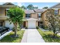 Charming townhome featuring a one car garage, wooden shutters and a cozy front porch at 207 Sterling Springs Ln, Altamonte Springs, FL 32714