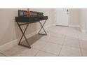 Stylish foyer featuring sleek tile flooring and a decorative console table, creating a welcoming entrance at 2168 Marsh Sedge Ln, Winter Park, FL 32792