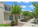 Charming home exterior with well-manicured landscaping, and sidewalk at 2952 Lucayan Harbour Cir # 106, Kissimmee, FL 34746