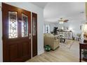 Inviting entryway with decorative glass doors that leads into the spacious, naturally lit living room at 30 Capistrano Dr, Ormond Beach, FL 32176
