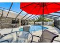 Enclosed backyard pool area with a screened enclosure and comfortable outdoor seating at 30 Capistrano Dr, Ormond Beach, FL 32176