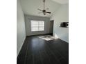 Bright bedroom with a ceiling fan, dark floors, natural light, and vaulted ceilings at 3337 Soho St # 205, Orlando, FL 32835