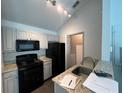 Efficient kitchen with stainless steel appliances, light countertops, and modern fixtures at 3337 Soho St # 205, Orlando, FL 32835