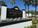 Elegant Avalon Condominiums sign featuring lush landscaping and palm trees on a bright, sunny day at 4405 S Semoran Blvd # 4, Orlando, FL 32822
