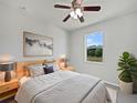Serene bedroom featuring a large window with outdoor views and soft natural light at 4841 Hickory Stream Ln, Mulberry, FL 33860