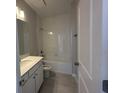 Clean bathroom featuring a shower-tub combo with tile surround and a modern vanity at 5268 Teirgarten St, St Cloud, FL 34771