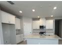 Bright kitchen with white cabinets, stainless steel appliances, and a center island at 5268 Teirgarten St, St Cloud, FL 34771