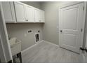 Functional laundry room with ample cabinet space and a utility sink at 5268 Teirgarten St, St Cloud, FL 34771