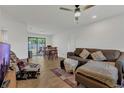 Inviting living room with lots of light, tile floors, modern ceiling fan, and direct access to the backyard at 5943 Sunderland Dr, Orlando, FL 32812