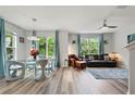 Bright open living space with modern furniture, wood floors, and large windows with vibrant green views at 6672 S Goldenrod Rd # 132B, Orlando, FL 32822