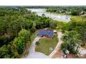 Panoramic aerial view of the charming brick home near a serene lake and lush greenery at 810 Alex Ln, Deltona, FL 32738