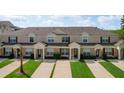 Inviting townhome showcases meticulous landscaping and well-maintained exteriors with a private entrance at 8110 Princess Palm Ln, Kissimmee, FL 34747