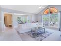 Bright living room featuring vaulted ceilings, large windows, and a modern white sectional sofa at 900 Northern Dancer # 204, Casselberry, FL 32707