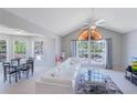 Bright, airy living room with vaulted ceilings and many windows and an adjacent dining area at 900 Northern Dancer # 204, Casselberry, FL 32707
