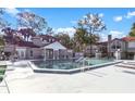 Community pool with beautiful clubhouse and lounge chairs, perfect for relaxation and recreation at 900 Northern Dancer # 204, Casselberry, FL 32707