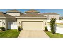 Spacious garage with well-kept landscaping, showcasing a clean driveway and enhancing property appeal at 10038 Verse Aly, Winter Garden, FL 34787