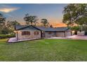 Charming single-story brick home with well-maintained lawn and colorful sunset sky at 11632 Lake Willis Dr, Orlando, FL 32821