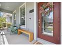 Inviting front porch with seating, decorative wreath on door, and clear numbering at 12127 Sonnet Ave, Orlando, FL 32832