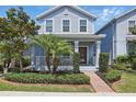 Beautiful two-story home featuring a landscaped front yard with a brick walkway leading to the porch at 12127 Sonnet Ave, Orlando, FL 32832