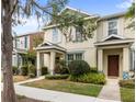 Well-maintained townhome featuring tidy landscaping and a welcoming entrance at 12977 Borland St, Windermere, FL 34786