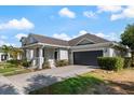 Well-manicured lawn accents this delightful home's exterior, complete with a two-car garage at 13609 Riggs Way, Windermere, FL 34786