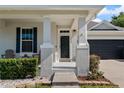 Inviting front entrance with decorative columns and well-kept landscaping adds to the home's curb appeal at 13609 Riggs Way, Windermere, FL 34786