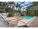 Enclosed backyard pool and spa surrounded by lush landscaping, perfect for outdoor relaxation at 13609 Riggs Way, Windermere, FL 34786
