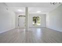 Open-concept living space with light flooring, large windows, and modern lighting fixtures at 1375 Willow Wind Dr, Clermont, FL 34711