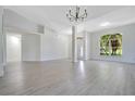 Spacious living room with light flooring, an open layout, and modern lighting at 1375 Willow Wind Dr, Clermont, FL 34711