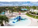 Community waterpark showcasing a vibrant splash pad and water slide, perfect for Gathering fun at 1425 Thunderbird Rd, Davenport, FL 33896