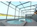 Gorgeous screened-in pool with hot tub overlooking the lake, offering privacy and stunning views at 1663 Lima Ave, Kissimmee, FL 34747
