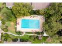 Aerial shot of a rectangular pool with lounge chairs and lush landscaping surrounding it at 200 Maitland Ave # 224, Altamonte Springs, FL 32701
