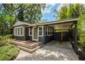 Charming home exterior boasting mature landscaping, a covered carport, and a brick paver driveway at 2020 Palmer St, Orlando, FL 32803