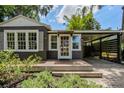 Inviting home exterior featuring a covered carport, mature landscaping and a beautiful front porch at 2020 Palmer St, Orlando, FL 32803