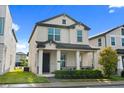 Charming two-story home featuring a covered front porch and well-maintained landscaping at 2405 Standing Rock Cir, Oakland, FL 34787