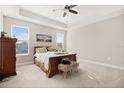 Comfortable main bedroom with ample natural light, carpeted floors, and neutral color palette at 2405 Standing Rock Cir, Oakland, FL 34787