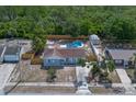 Charming home featuring a private pool, fenced yard, shed, and lush surrounding greenery at 2763 E Waco Dr, Deltona, FL 32738