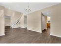 Open-concept living area with staircase, hardwood floors, and natural light, offering ample space for relaxation and entertainment at 2995 White Magnolia Loop, Clermont, FL 34711