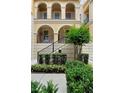 Charming three-story townhouse featuring arched entry, private balconies, and landscaped front yard at 3333 Messina Dr, Lake Mary, FL 32746