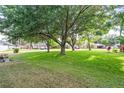 Spacious front yard with mature trees providing ample shade and a serene atmosphere at 346 Hickory Springs Ct, Debary, FL 32713