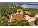 A large parcel of land with mature trees and an attractive home by a lake at 36408 E Eldorado Lake Dr, Eustis, FL 32736