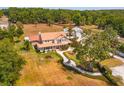 Expansive property featuring a traditional home and a separate garage at 36408 E Eldorado Lake Dr, Eustis, FL 32736