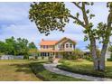 Charming home with a well-kept lawn and a quaint fountain feature at 36408 E Eldorado Lake Dr, Eustis, FL 32736
