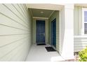 Inviting front porch with double doors and neutral siding at 4351 Finch Ln, Kissimmee, FL 34746