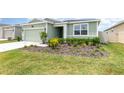 Beautifully landscaped front yard with colorful plants and mulch at 4351 Finch Ln, Kissimmee, FL 34746