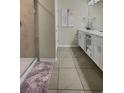 Modern bathroom featuring a double vanity and glass shower at 4751 Clock Tower Dr # 103, Kissimmee, FL 34746